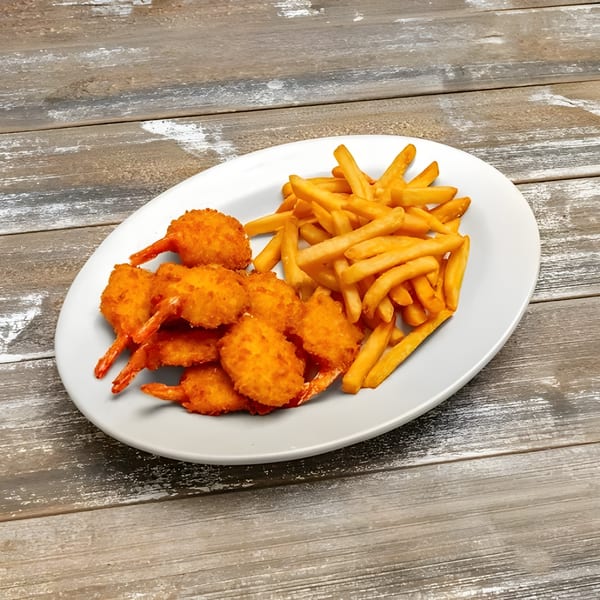A white oval plate filled with golden-brown fried shrimp and a pile of crispy french fries.